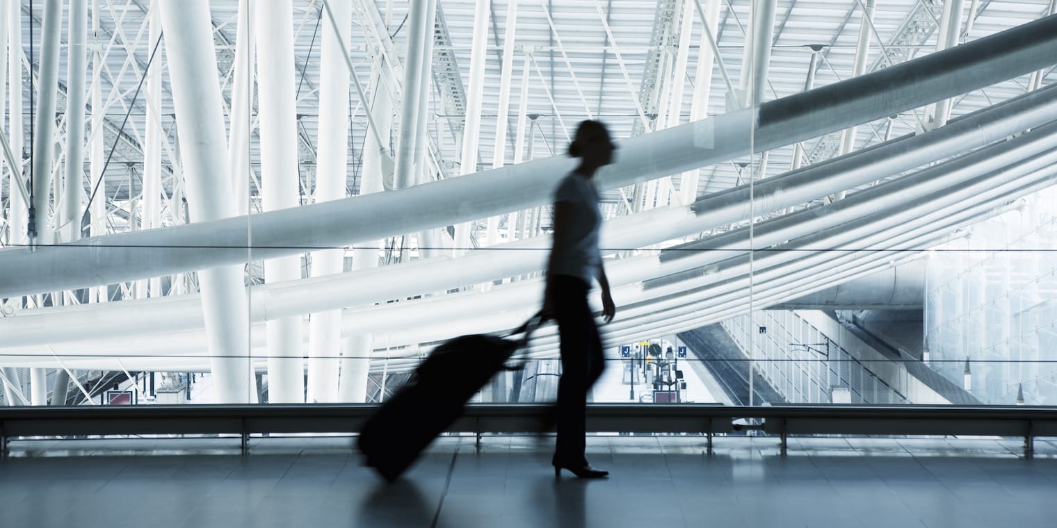 future of business travel - blurry traveler in airport