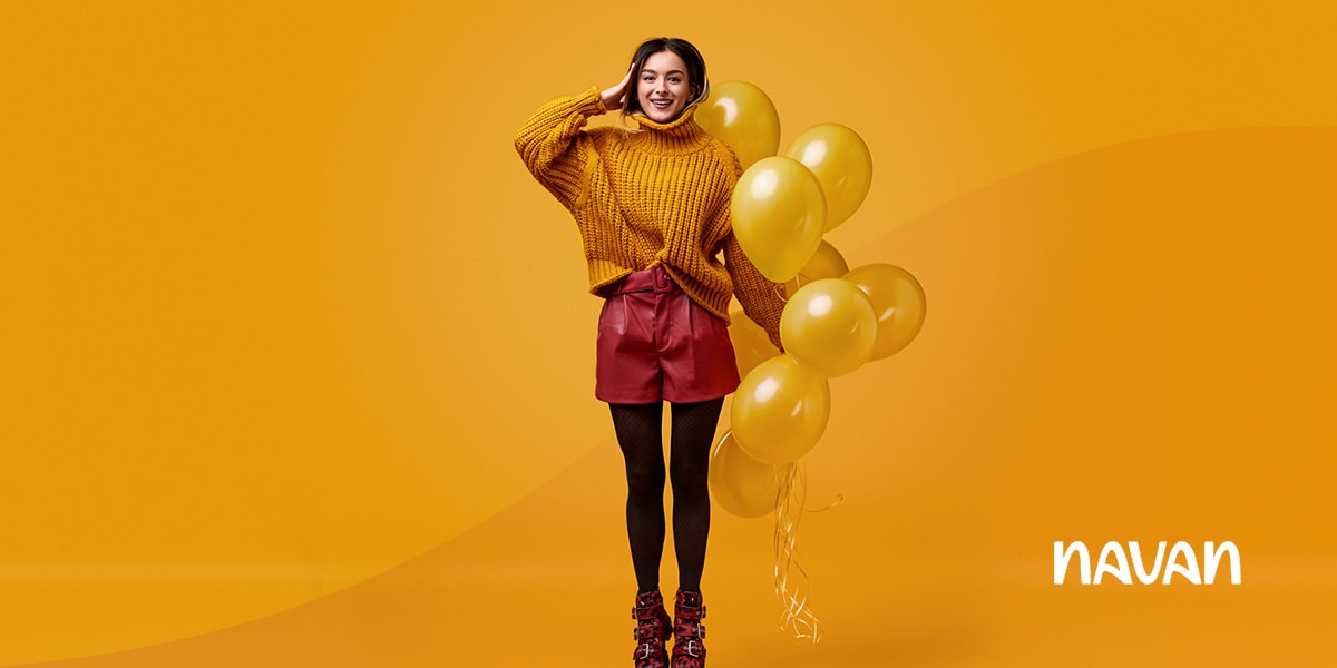 woman with balloons who is happy because she has created and manages a successful corporate travel programme