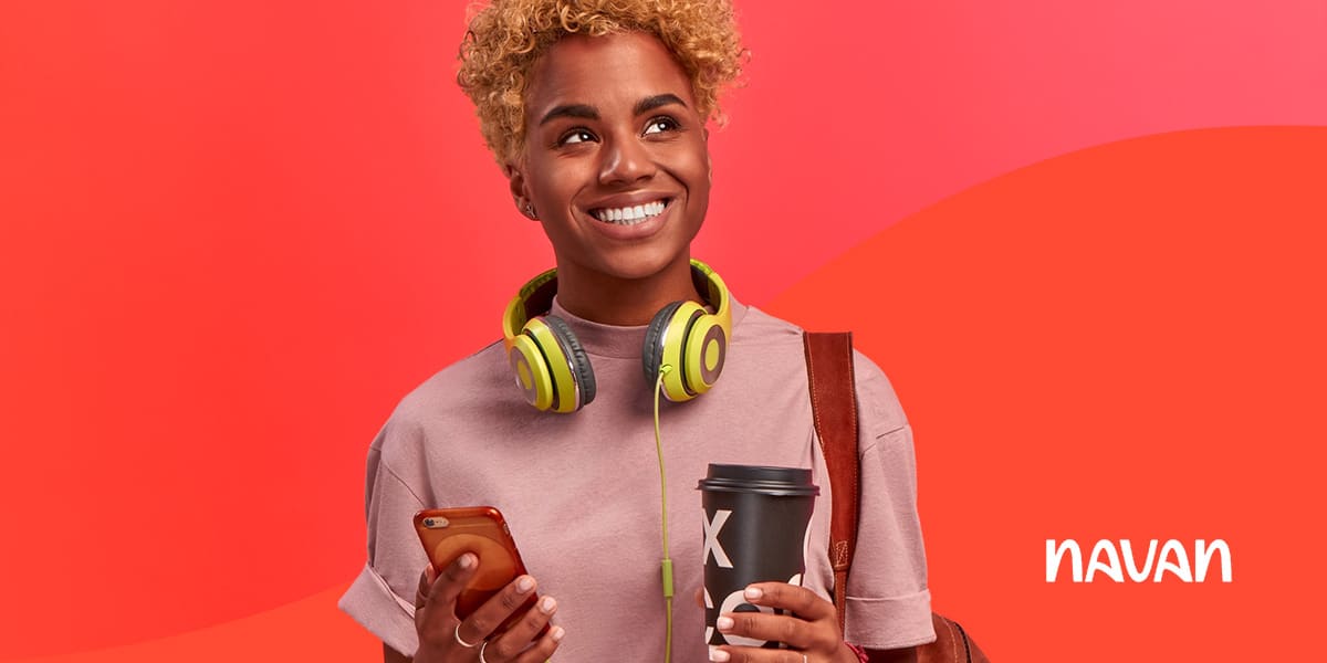 How to Have Fun on a Business Trip - A Woman with a cell phone, coffee, and headphones