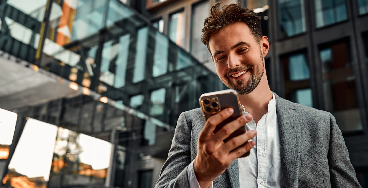 Penn Group Case Study - Man in front of building holding phone