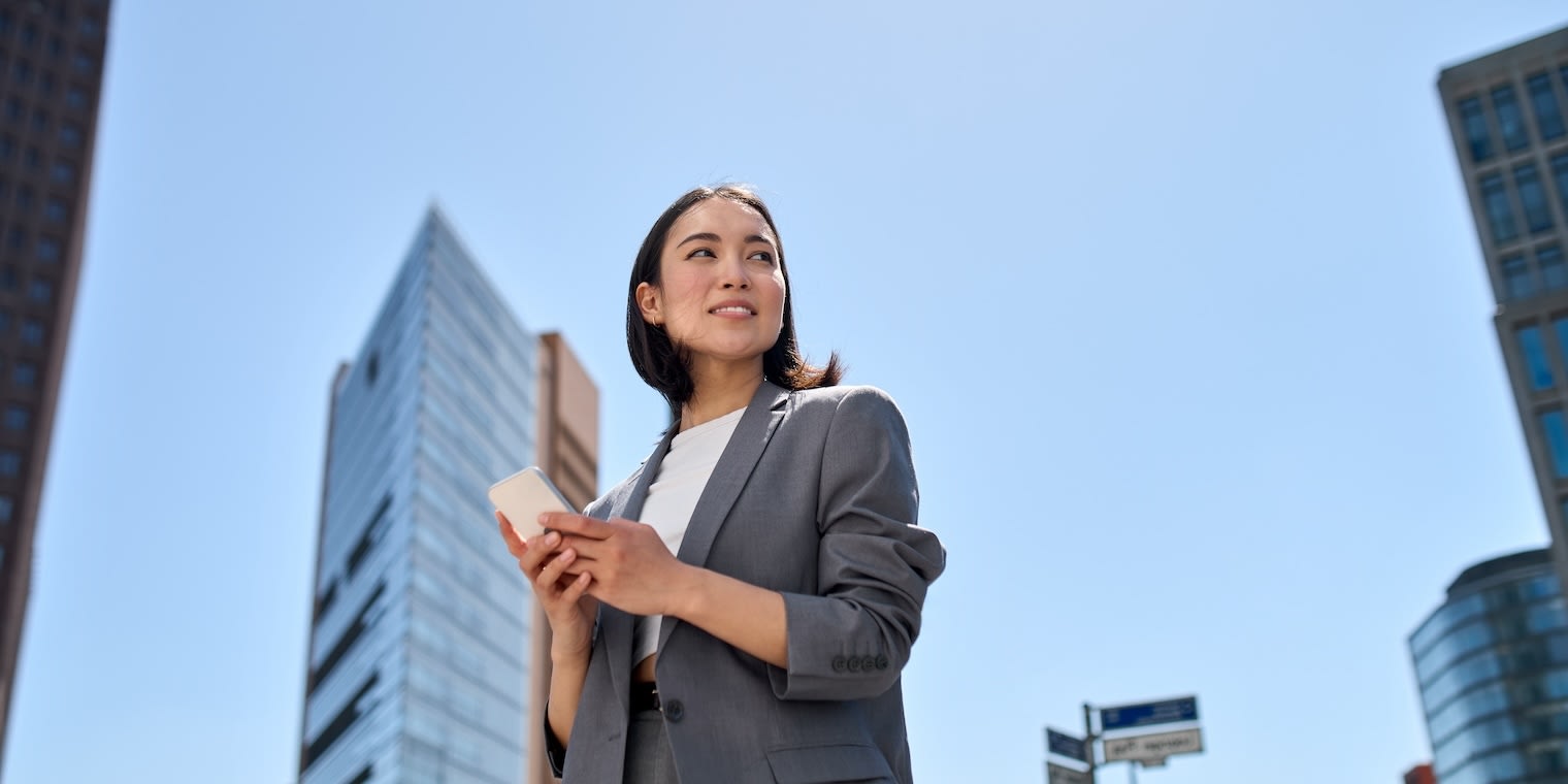 woman with phone - travel and expense management