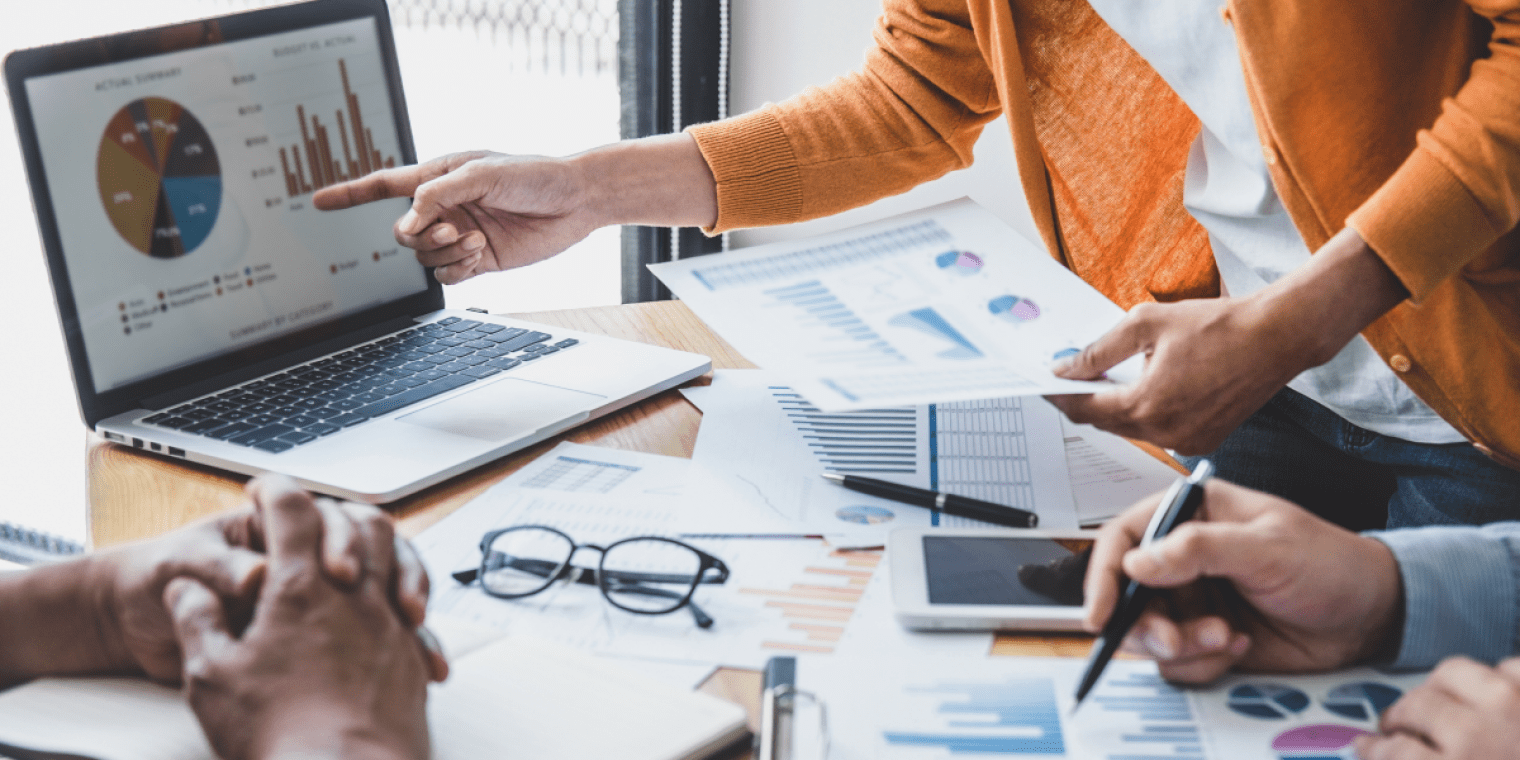 business expense management hand pointing at computer with graph