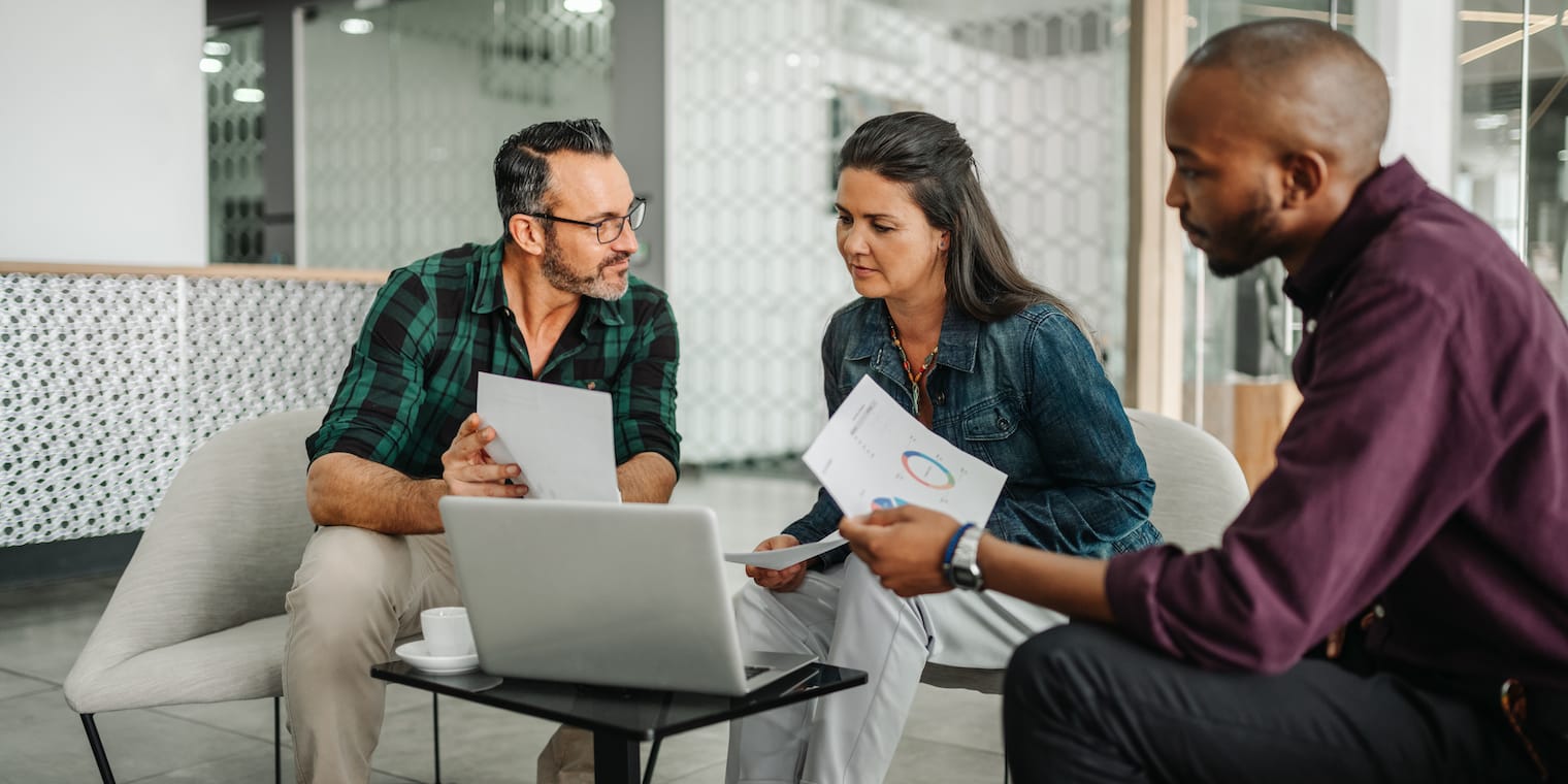 expense management companies people debating in front of computer