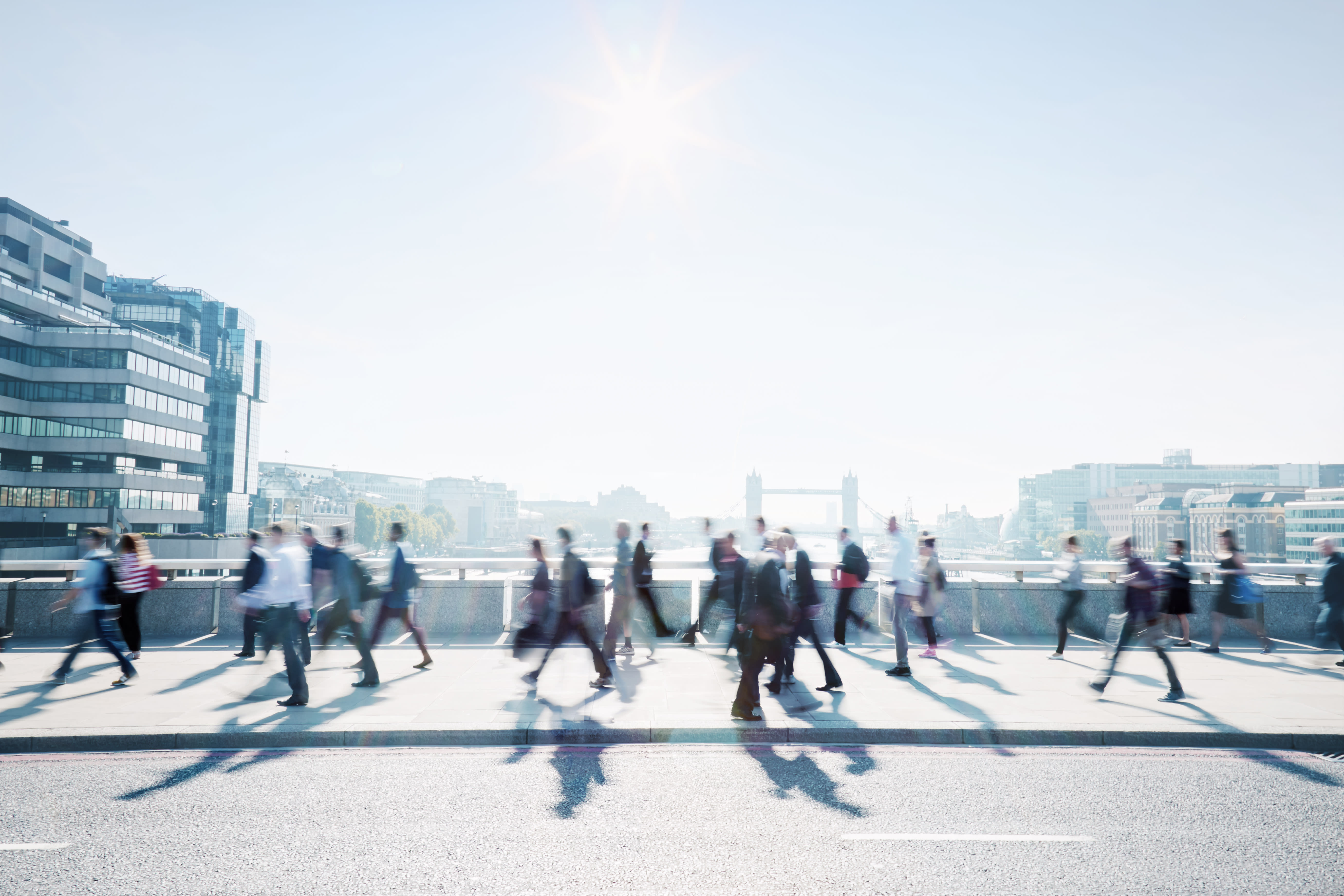 Business travellers crossing a bridge in London.