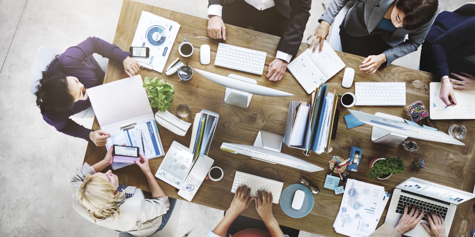 expense management software for small business people having a meeting around a table
