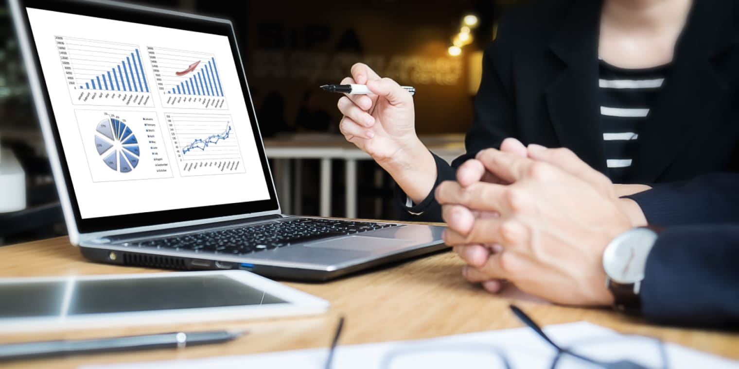 expense management system screen with data and two people