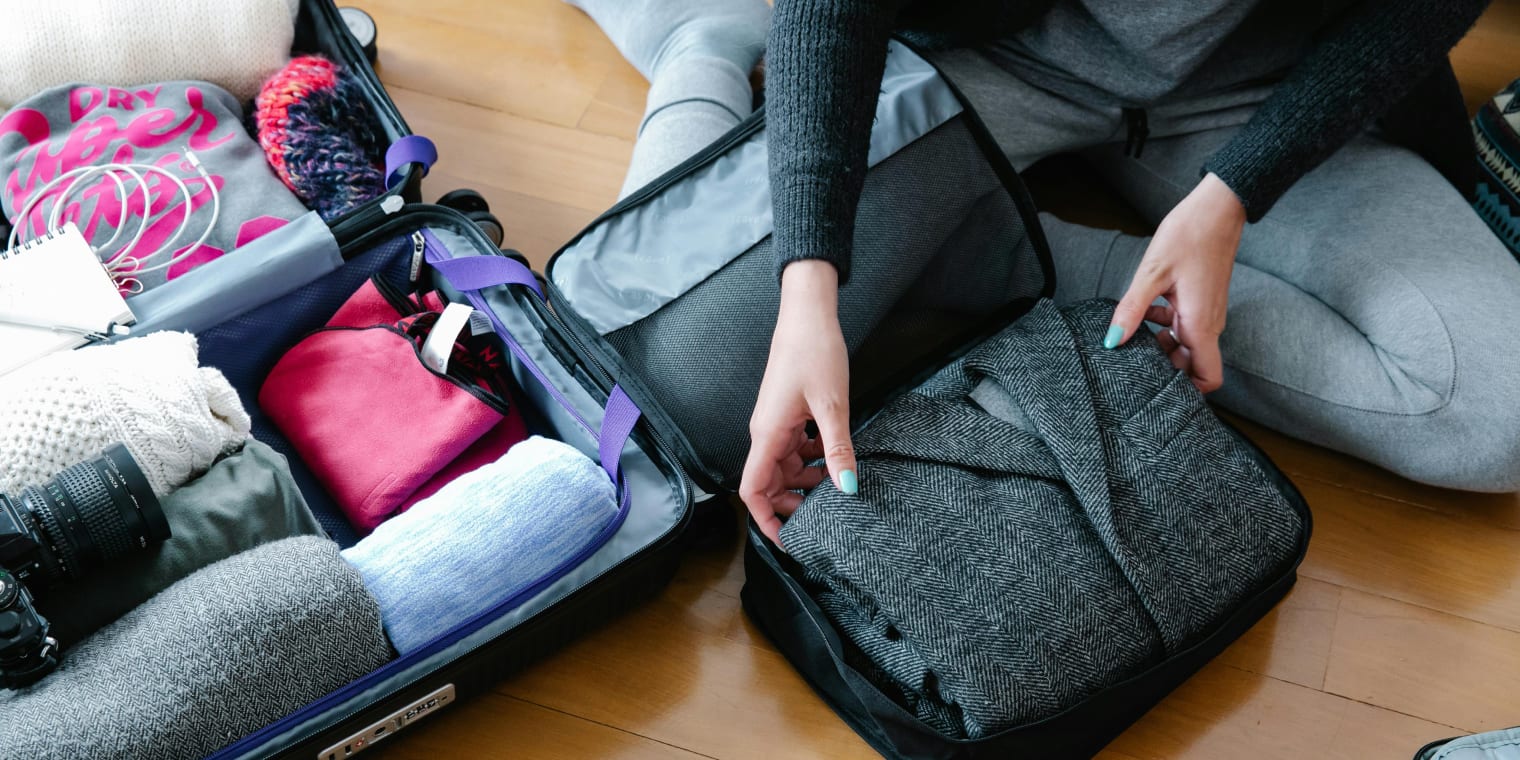 Carry-on bag with rolled clothes. Business Trip Packing List