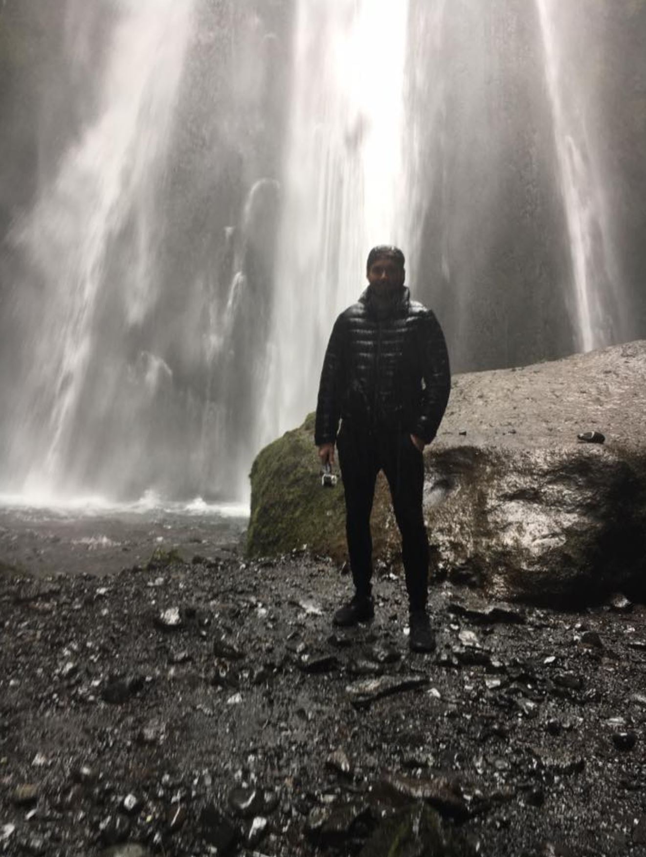 Inside a cave behind the waterfall