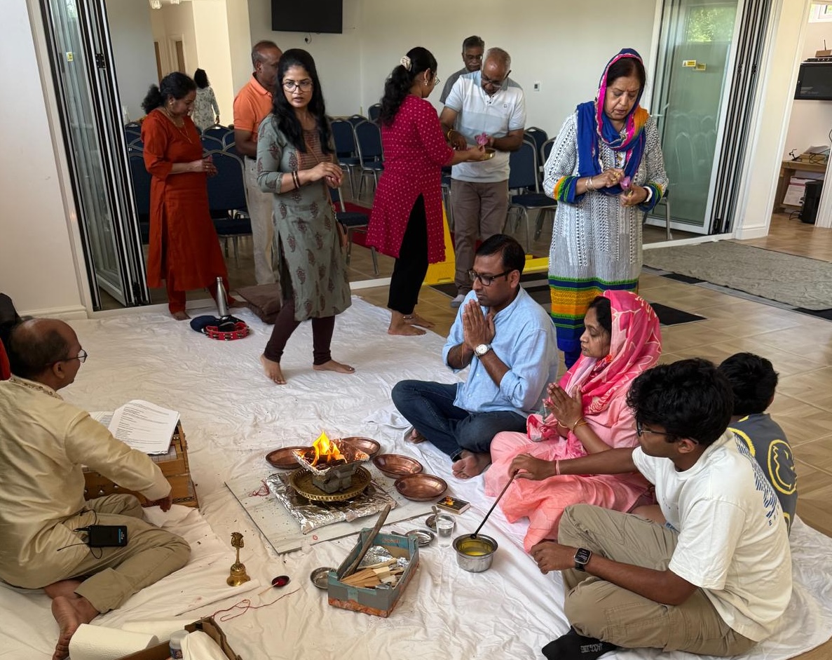 Priest and devotees during the monthly havan ceremony