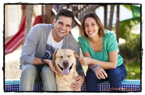 happy couple with labrador retriever