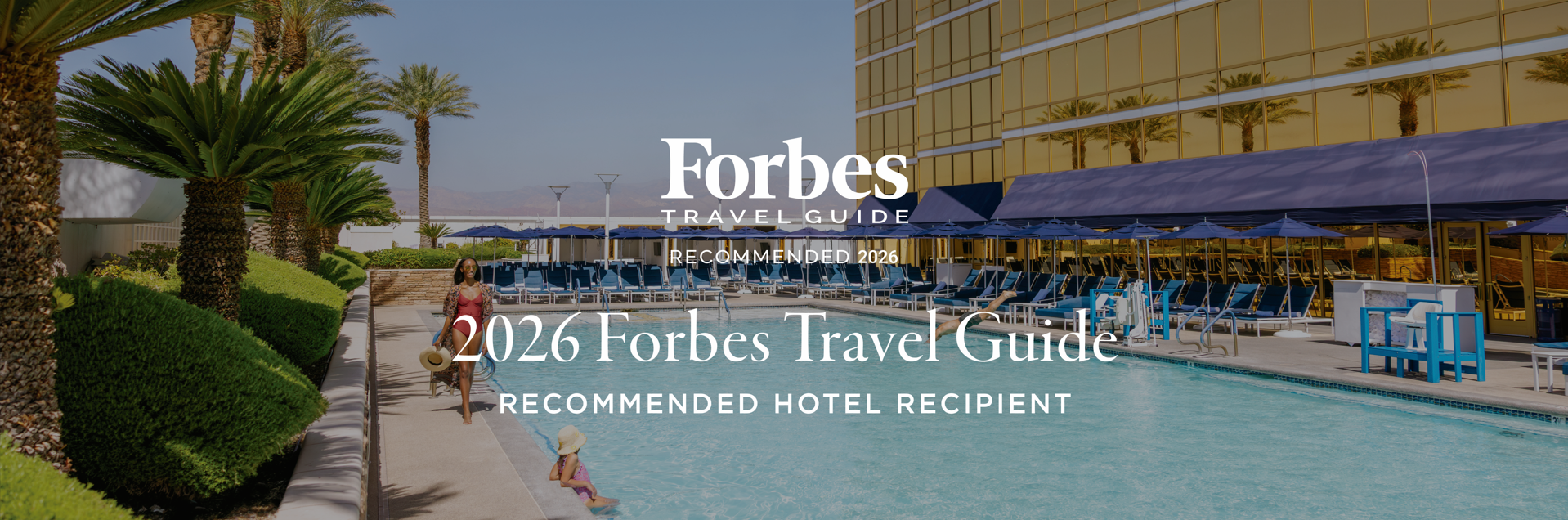 An image of a suite with 'Forbes Travel Guide' and 'Five-Star Award' visible at the foreground