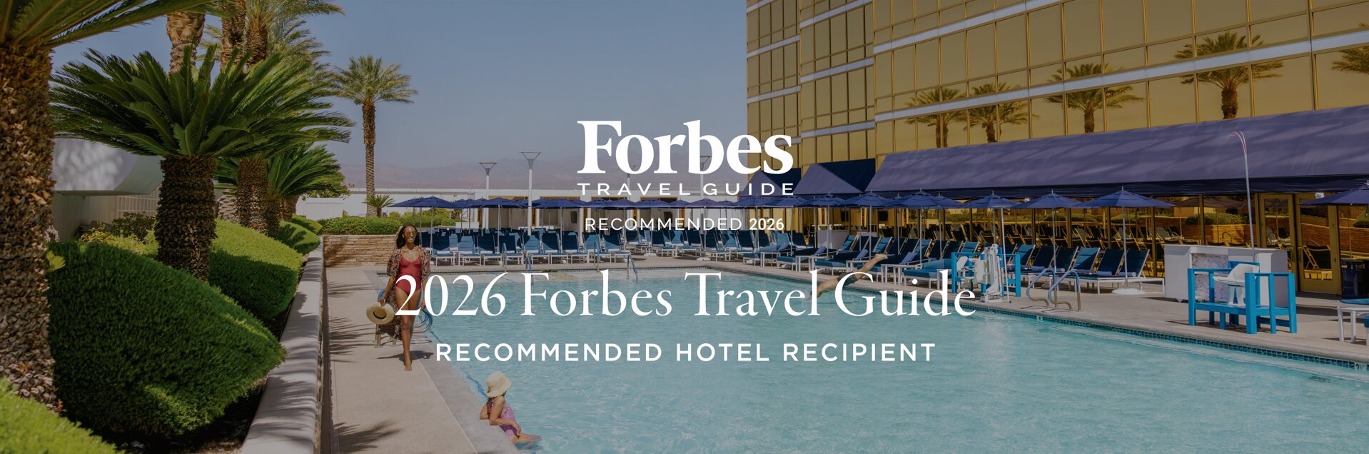 An image of a suite with 'Forbes Travel Guide' and 'Five-Star Award' visible at the foreground