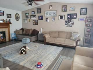 Open living room with plenty of comfortable seating that leads to the outdoor deck.