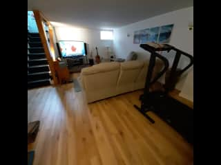 Family room with TV and treadmill.