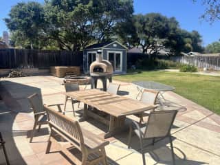 Patio table, pizza oven, spa, and she shed (with Peleton)