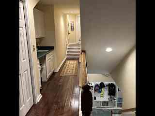 Stairs to the upstairs game room with billiards and views of the lake and golf course.