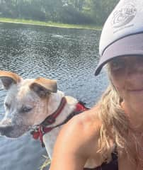 Teaching B how to sit quietly on a paddle board