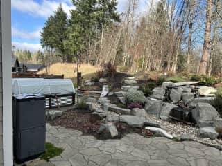 Waterfall, garden beds and hot compost bin.