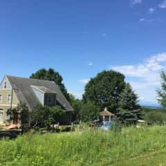 Back view of house.  House is passive and active solar so most windows face southeast. Lots of room and privacy