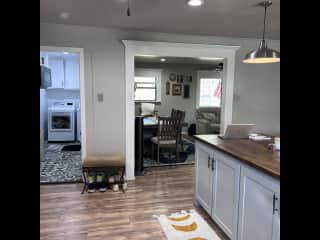 Kitchen leading into dining/living room space and laundry/pantry.