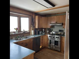 Kitchen with gas stove and oven, dishwasher, fridge and freezer. No microwave.