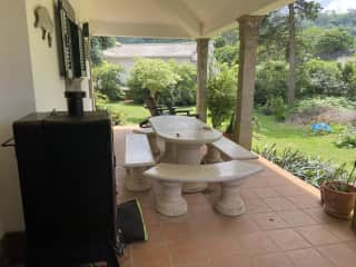 Back porch with a large outside eating area.