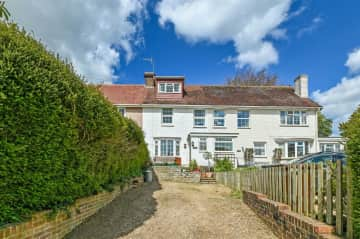 Front of house - terraced with parking for two cars and a front porch with bench for sitting in the sun