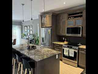 Kitchen with new appliances including induction stovetop and air fryer oven.