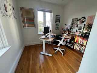 Quiet light-filled private office with adjustable standing desk on 2nd floor above kitchen