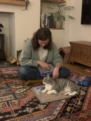 Gabi doing a puzzle with her family's cat, Luna