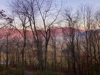 Sunrise view looking left from our front porch one morning in March. We have extraordinary colors when the mist lays low.