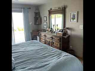 Master Bedroom for you.  King size bed. Sliding glass doors to deck with hot tub.