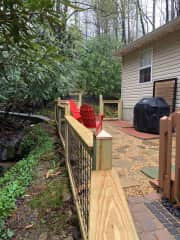 Our enclosed back yard sitting area is next to a mountain stream.