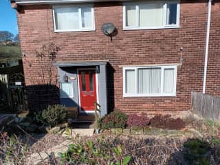 front of the house, garden has a narrow border and the rest is pebbles and paving.