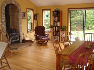 Family room with wood stove and sliding door to backyard