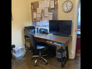 Work space in the spare bedroom with a small tv