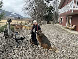 Heidi in front of the house with Bentley and Holly