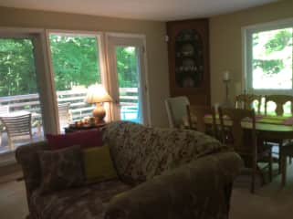 Living room which opens on to the back porch. Table, chairs and sitting area not yet set up this season