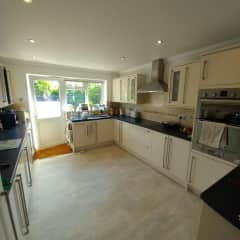 Kitchen with cooker, hob, microwave, dishwasher & washing machine.