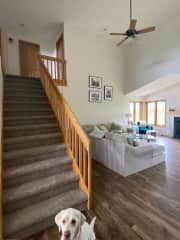 Living room and stairs leading to guest bedrooms and bathroom