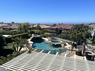 Backyard from balcony view. Pool spa fire pit bbq