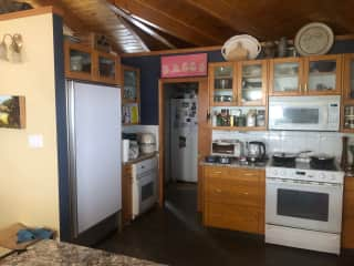 Another view of the kitchen showing access to the standup deep freeze and Laundry room.  A large pantry is around that corner to the right.