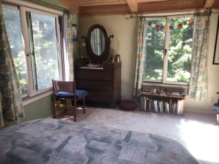 The bedroom looks out onto the redwoods