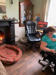 This is me, in the office.  Two of us work in here every day, so there are two desks, and the router/wifi is in here. I often light the fire in here if it's chilly.  There's a sofa too - Dora tends to snooze there during the day whilst we work