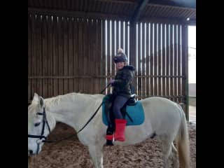 Zea riding in exchange for cleaning out the stables.