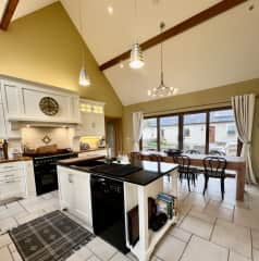 Kitchen for budding chef's  looking out onto courtyard with door at right leading to entryway, ground floor.