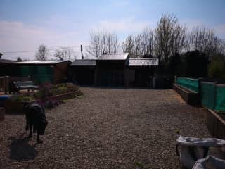 Barns with roofed area to the left where the pool is