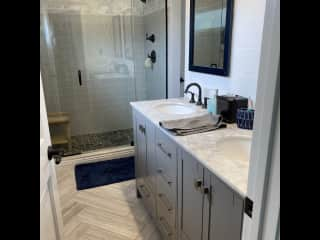 Recently updated bathroom with a walk in shower and double sinks