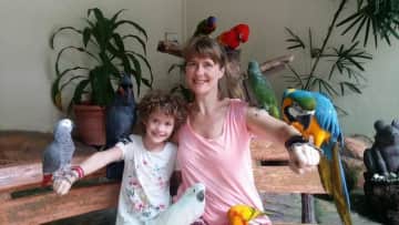 My daughter and I enjoying the company of parrots.