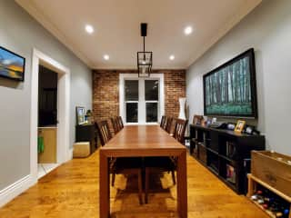 The spacious dining area. The brick wall is a deconstructed 1912 chimney sourced from a demolition at another address.